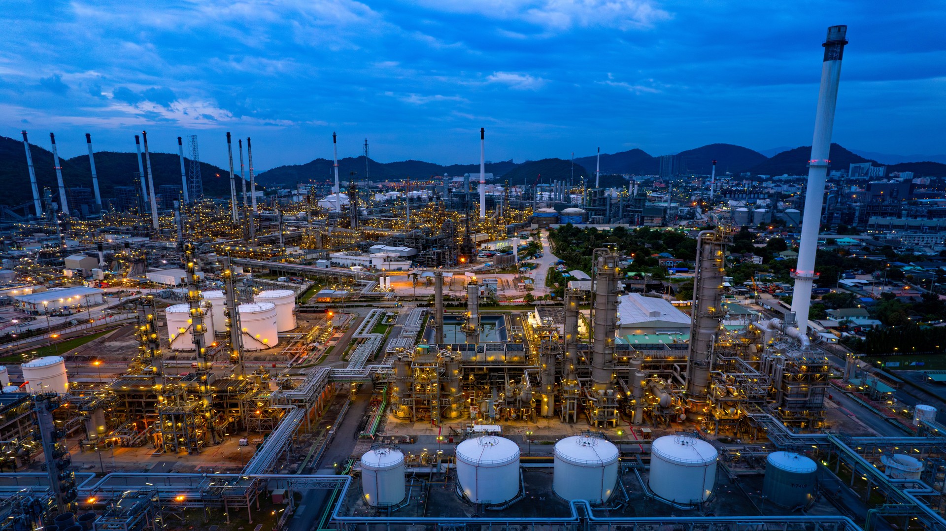 aerial view oil refinery Oil and gas industry, petrochemical plant area and energy concept, oil storage tanks at night time with lights.